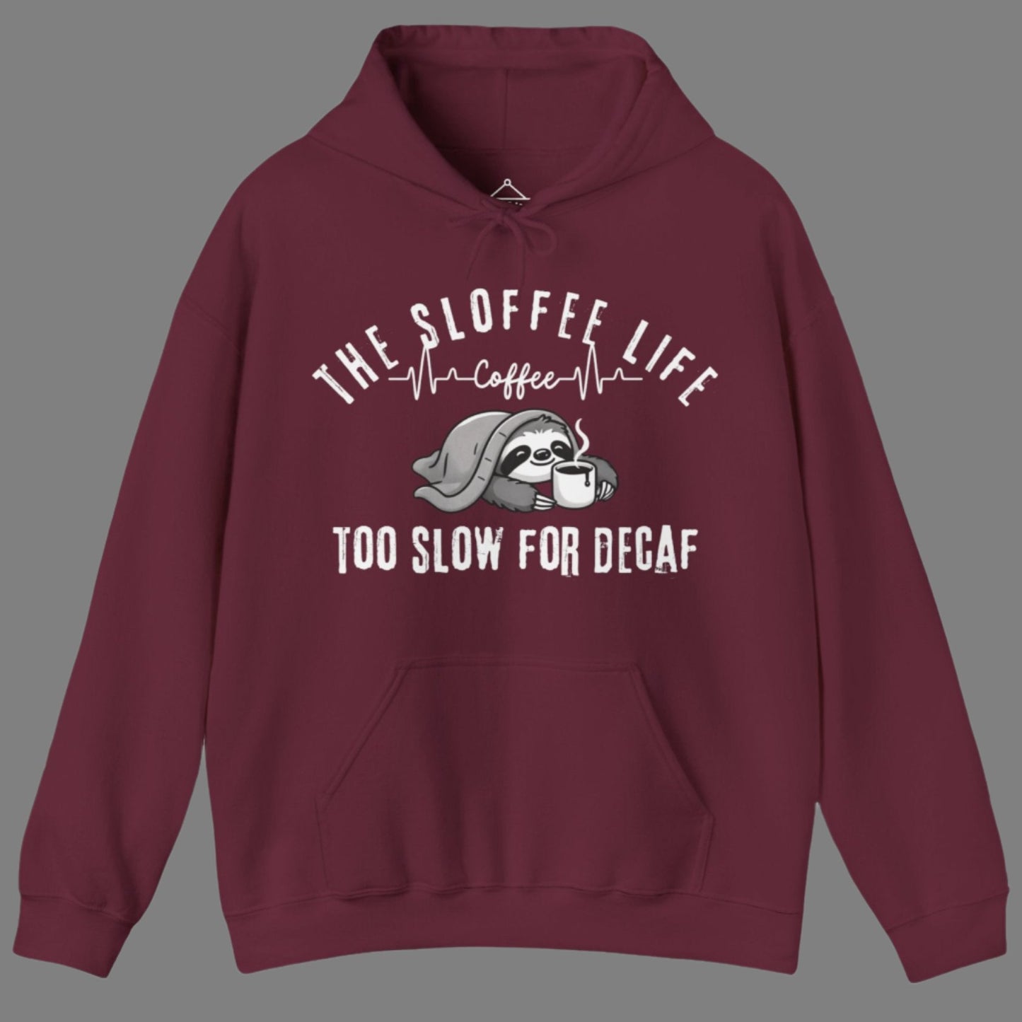 The Sloffee Life Too Slow For Decaf hoodie in maroon featuring a sloth under a blanket holding a coffee cup