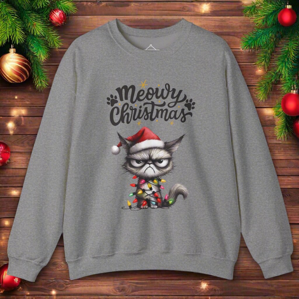 Grumpy Meowy Christmas Sweatshirt graphite heather with the words Meowy Christmas and a grumpy cat with a red hat and wrapped up in lights