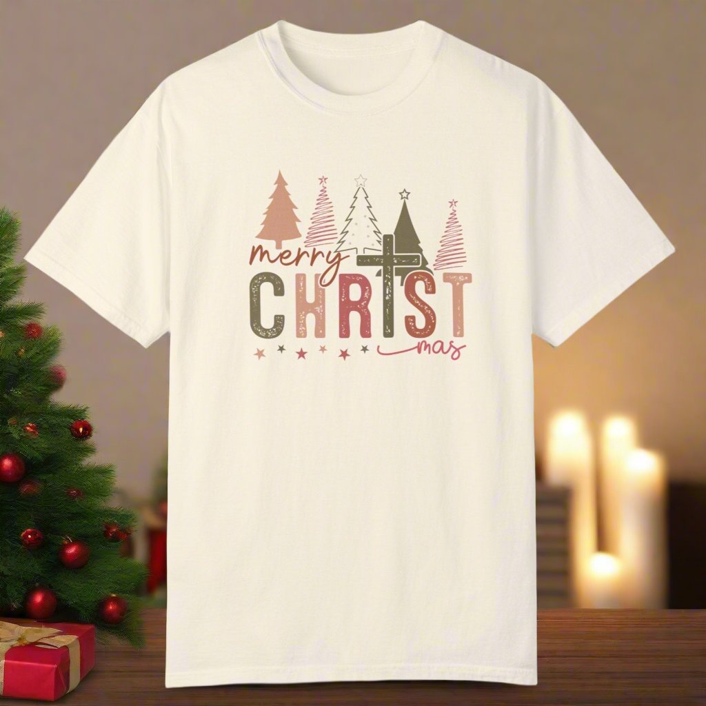 The christmas cross shirt in ivory with a cross as the T and christmas trees in the background