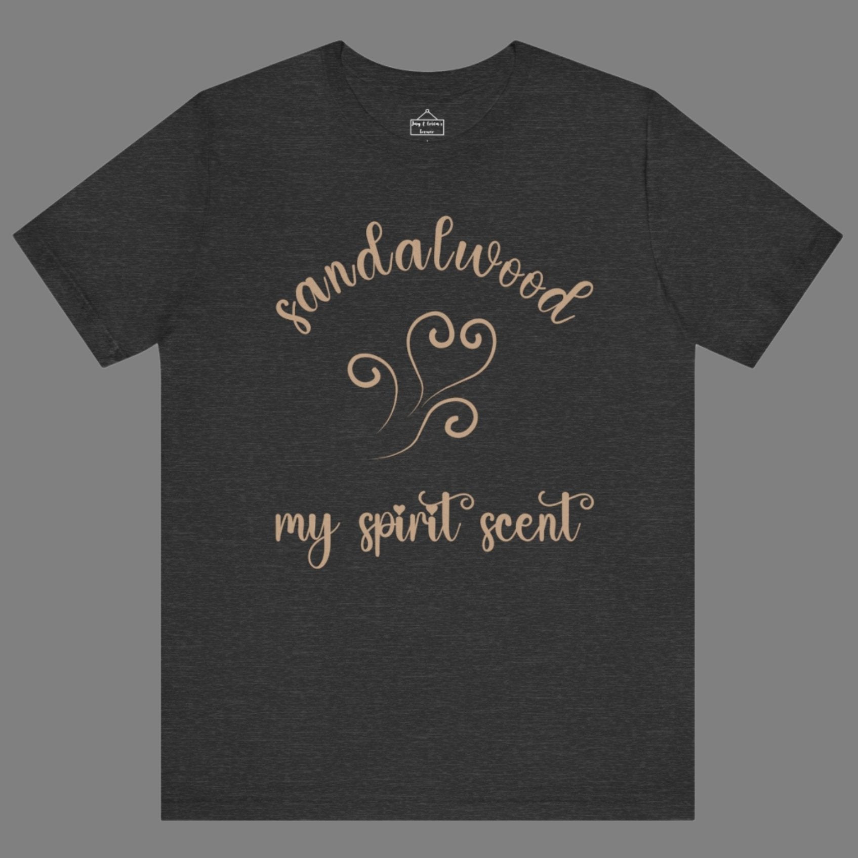 The My Spirit Scent is Sandalwood t-shirt dark grey heather featuring script font and an aroma script heart in a warm, muted beige hue