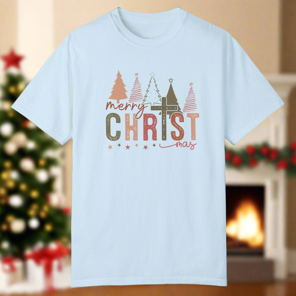 The christmas cross shirt in chambray with a cross as the T and christmas trees in the background