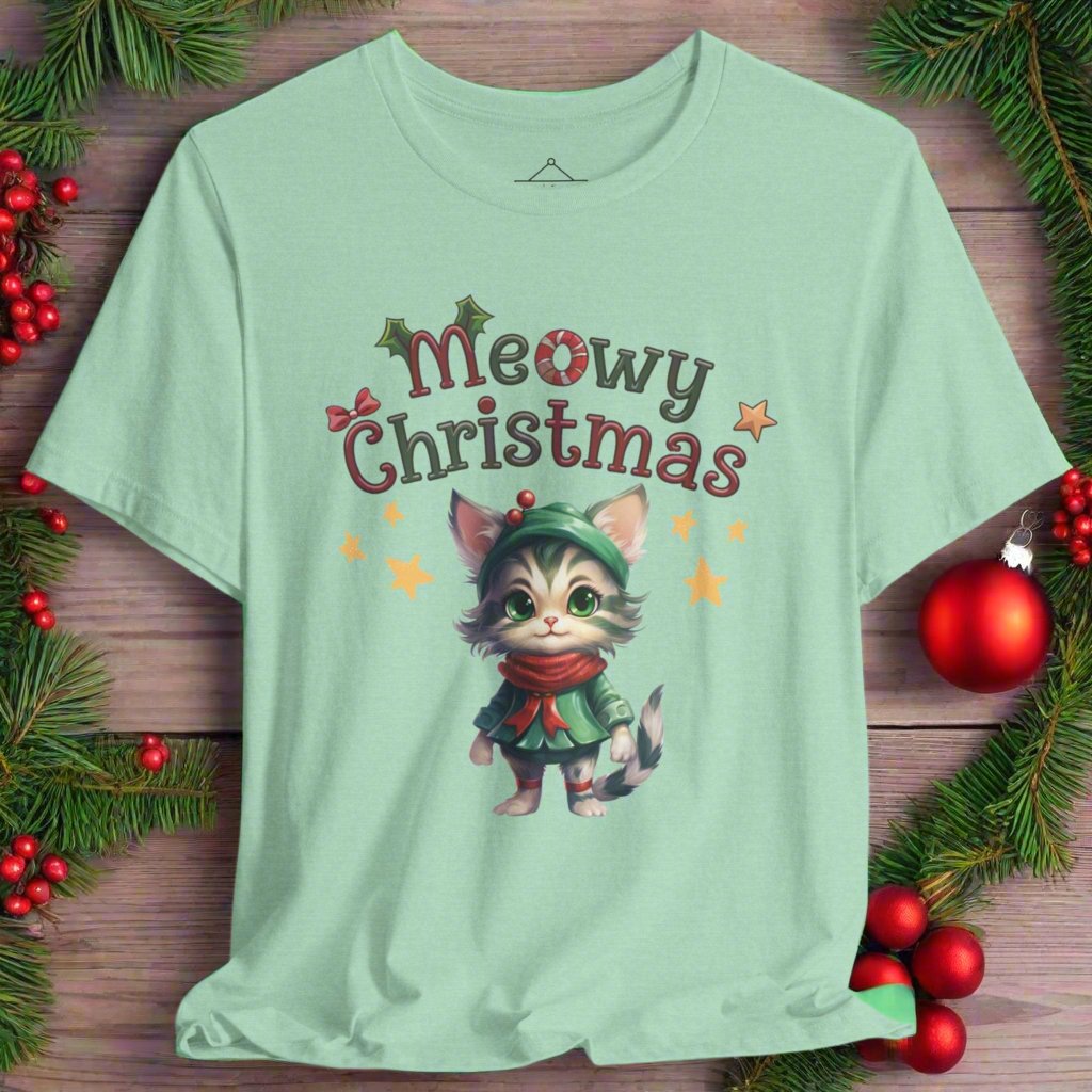 Meowy Christmas t-shirt in heather mint featuring a cute cat wearing a green dress, red scarf and green hat