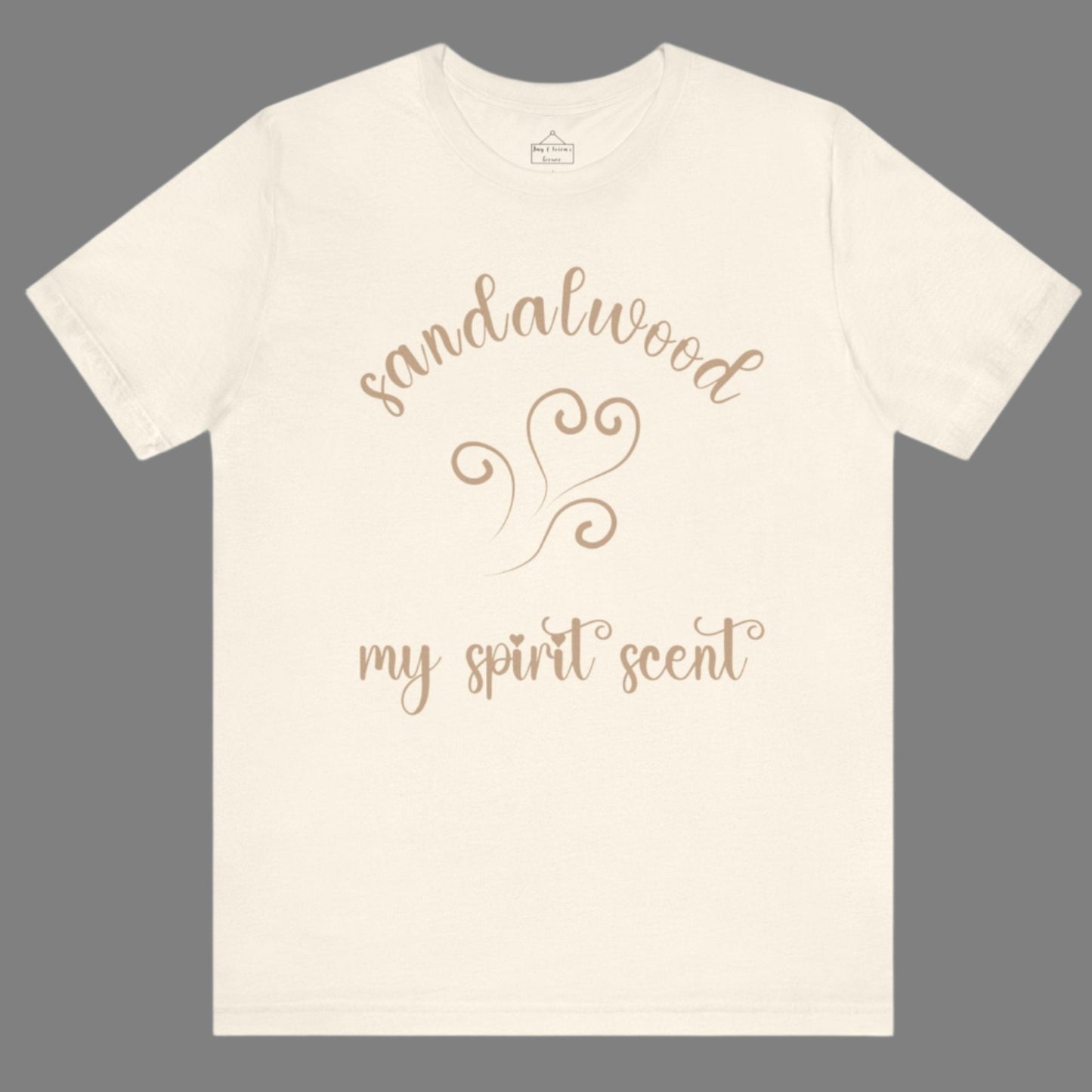 The My Spirit Scent is Sandalwood t-shirt in natural featuring script font and an aroma script heart in a warm, muted beige hue