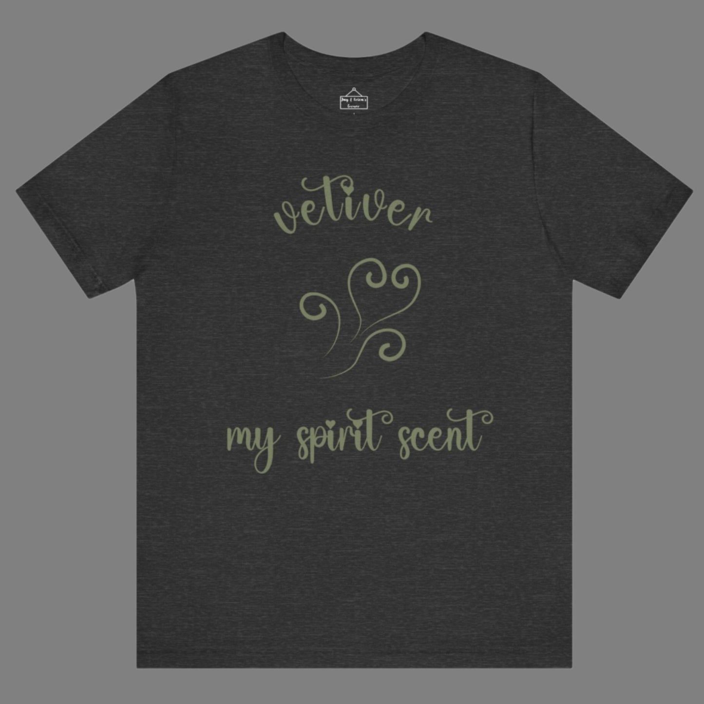 The My Spirit Scent is Vetiver t-shirt in dark grey heather featuring script font and an aroma script heart in a grey-green hue