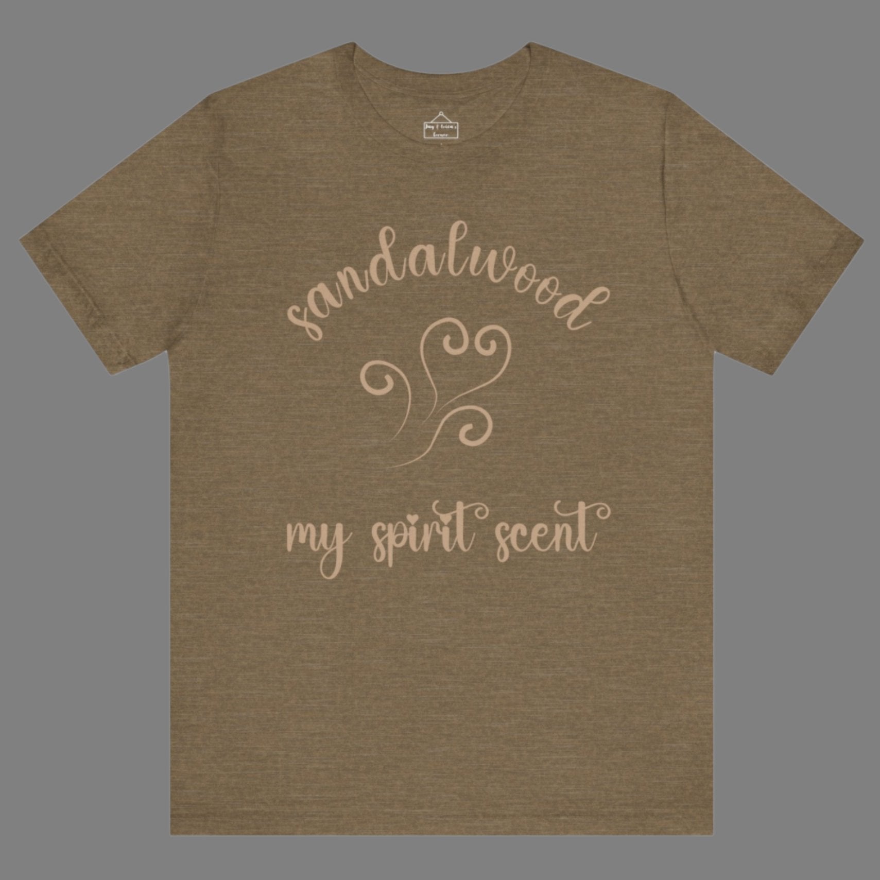 The My Spirit Scent is Sandalwood t-shirt in heather olive featuring script font and an aroma script heart in a warm, muted beige hue