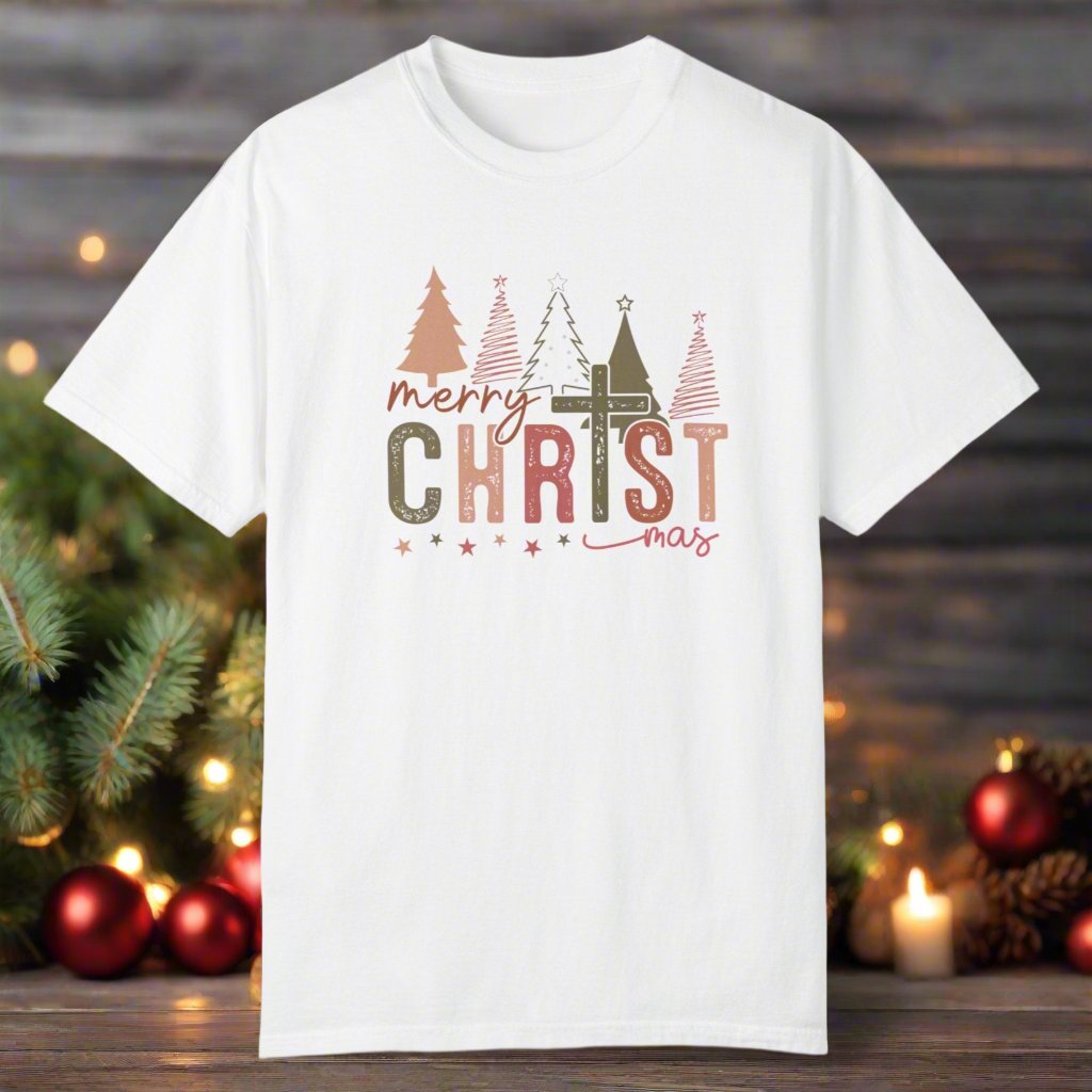 The christmas cross shirt in white with a cross as the T and christmas trees in the background