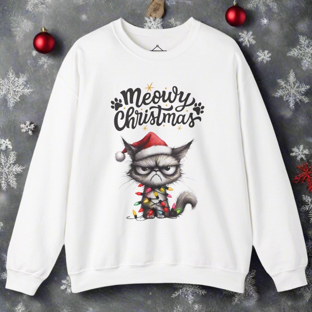 Grumpy Meowy Christmas Sweatshirt in white with the words Meowy Christmas and a grumpy cat with a red hat and wrapped up in lights