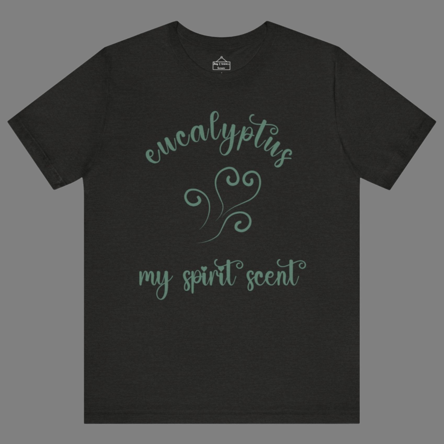 The My Spirit Scent is Eucalyptus t-shirt in black heather featuring script font and an aroma script heart in a blue-green hue