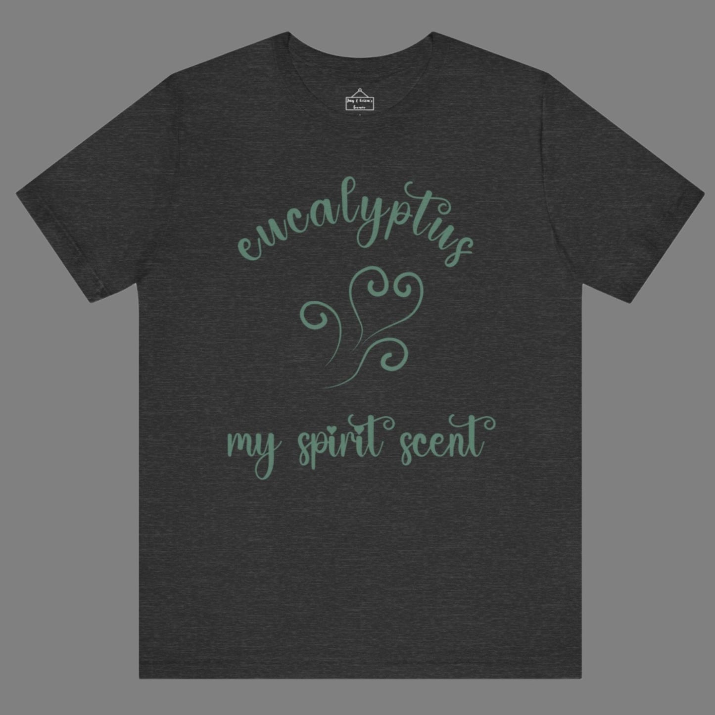 The My Spirit Scent is Eucalyptus t-shirt in dark grey heather featuring script font and an aroma script heart in a blue-green hue