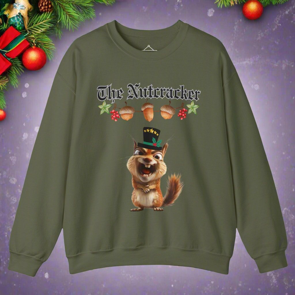 The Nutcracker christmas sweatshirt in military green featuring a strand of acorns hanging above a squirrel making a goofy face wearing a black top hat with a green ribbon and gold stars