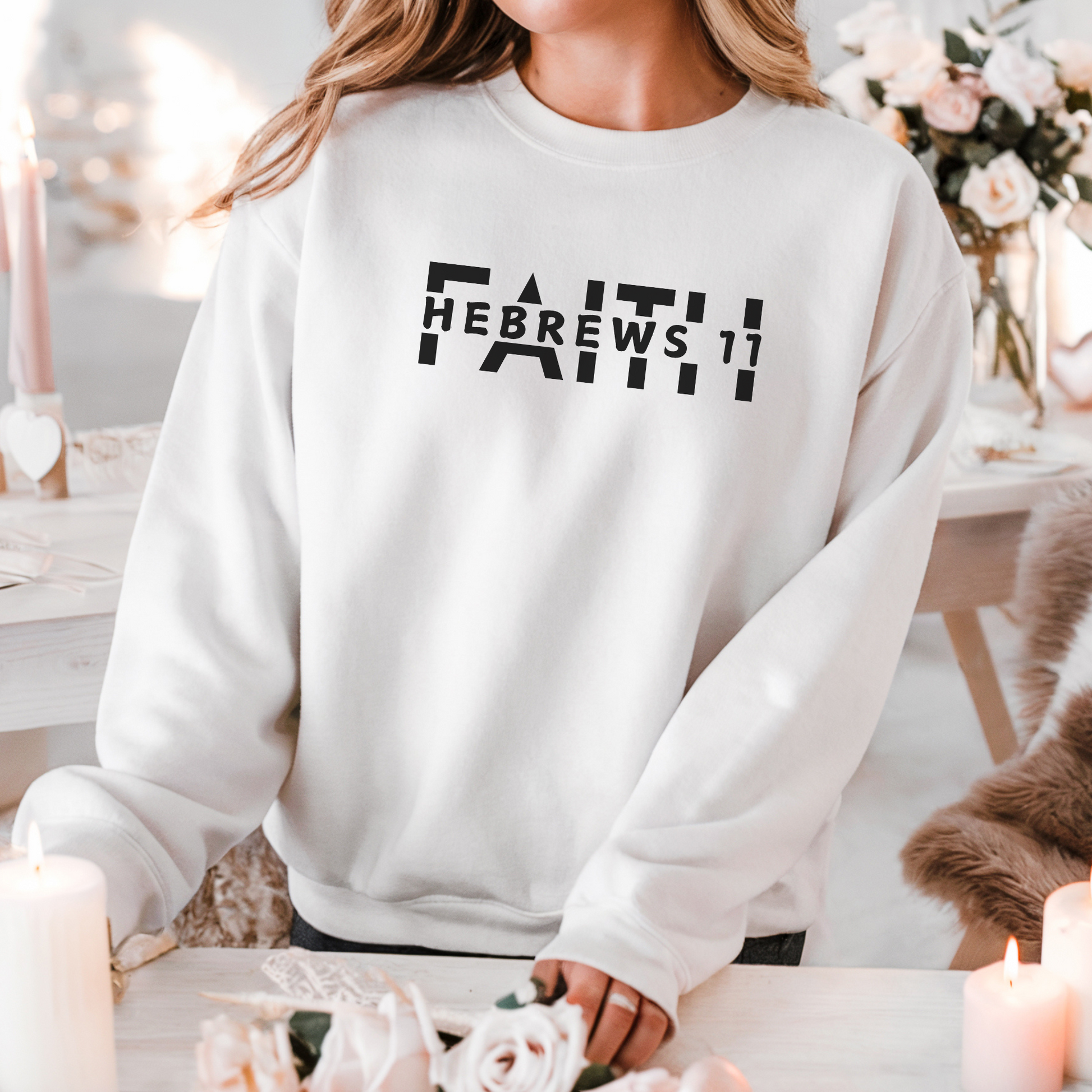 A smiling woman wearing the FAITH Hebrews 11 sweatshirt in white featuring the word faith with Hebrews 11 cut between the letters all in black print