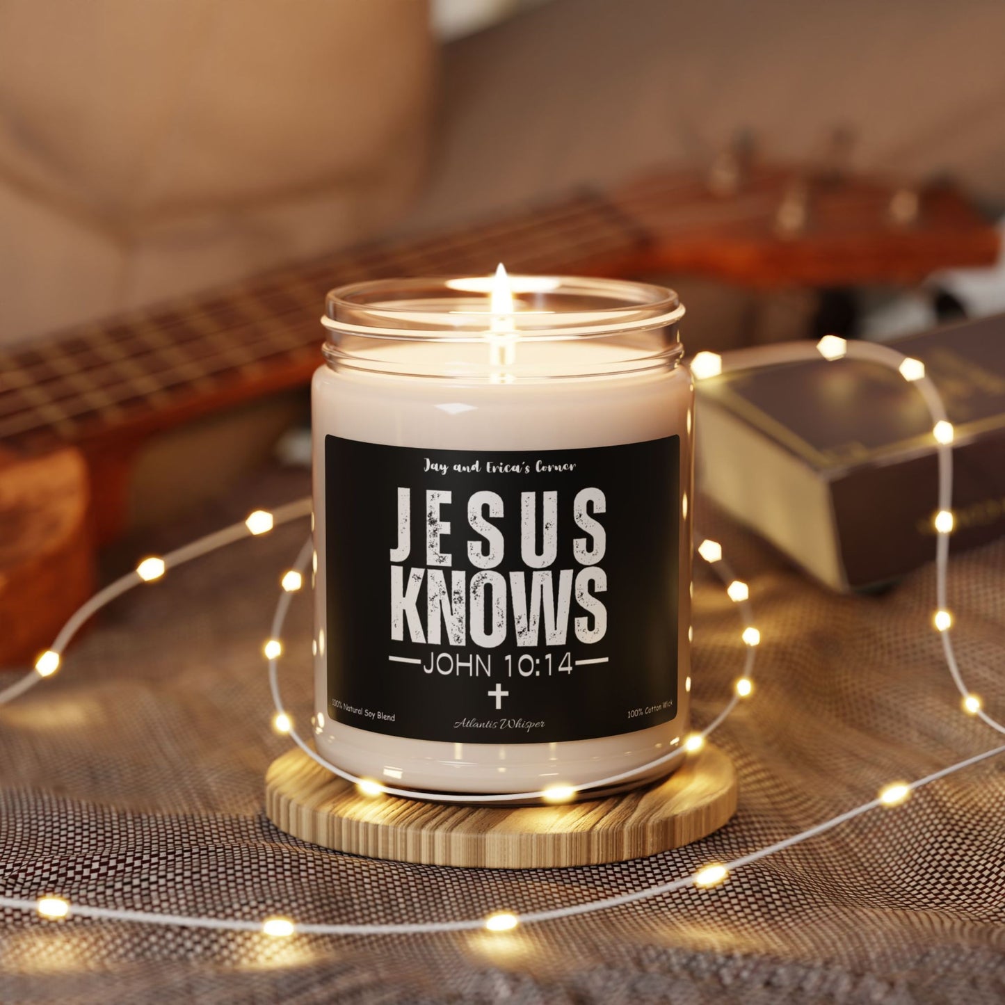 Jesus Knows John 10:14 scented soy candle in a clear glass jar, a black label, and white font